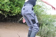 Industrial Mud Trousers view details of set gm-2m11, Lady-A wears grey work trousers and a black swimsuit into the mudbanks