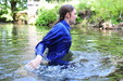 Cold Water Chastity view details of set gm-2w81, Wearing a blue boilersuit and wellies into the cold river
