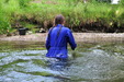 Cold Water Chastity view details of set gm-2w81, Wearing a blue boilersuit and wellies into the cold river