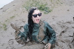 Green waterproofs in the mud