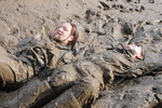 Green waterproofs in the mud