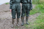 Green waterproofs in the mud
