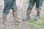 Green waterproofs in the mud